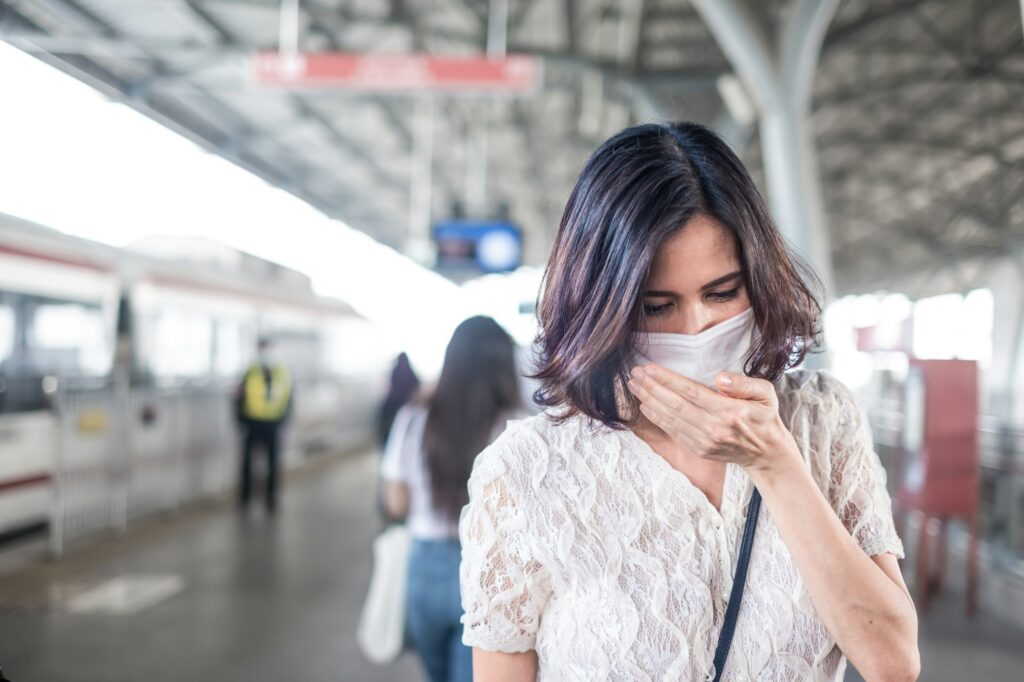 Asian woman wearing mask for prevent dusk pm 2.5 bad air pollution and coronavirus