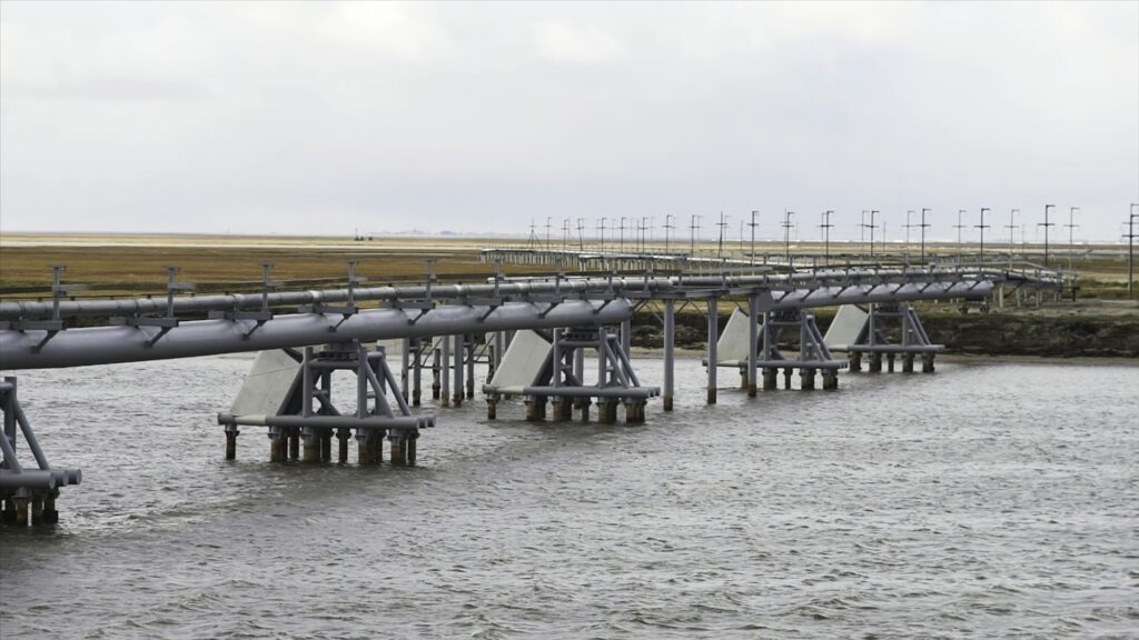 Canal watercourse waterway of water supply with water pipe in countryside. water pump on a river