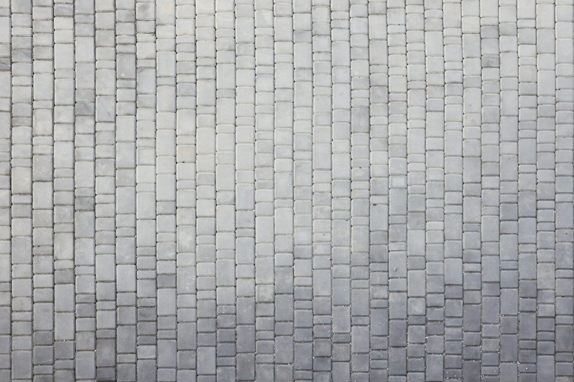 Gray color paving slabs in the pedestrian street sidewalk