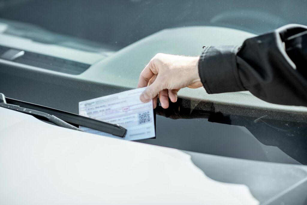 Policeman putting fine on the car