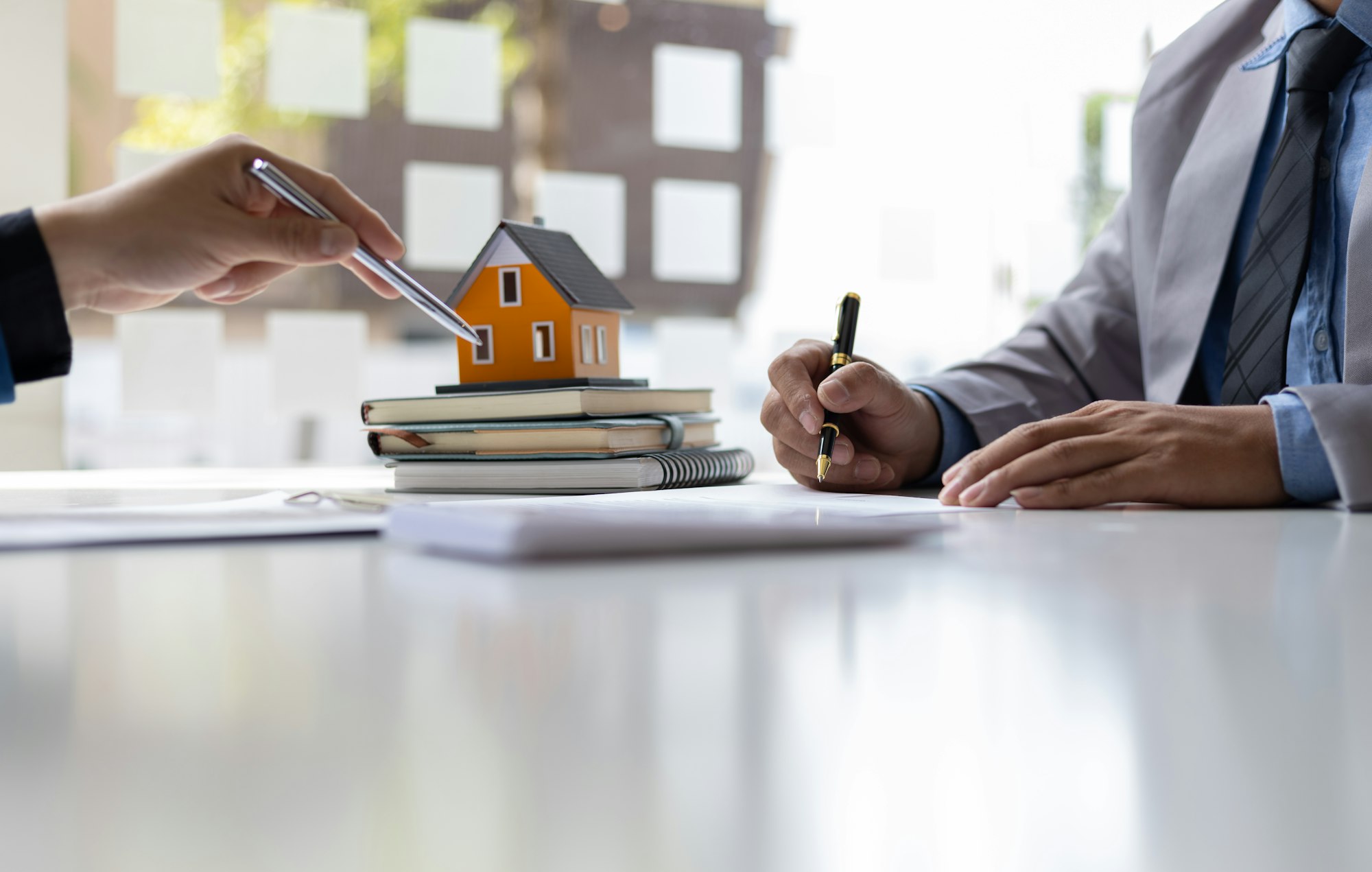 Real estate agent is discussing and explaining the terms of the home purchase contract.