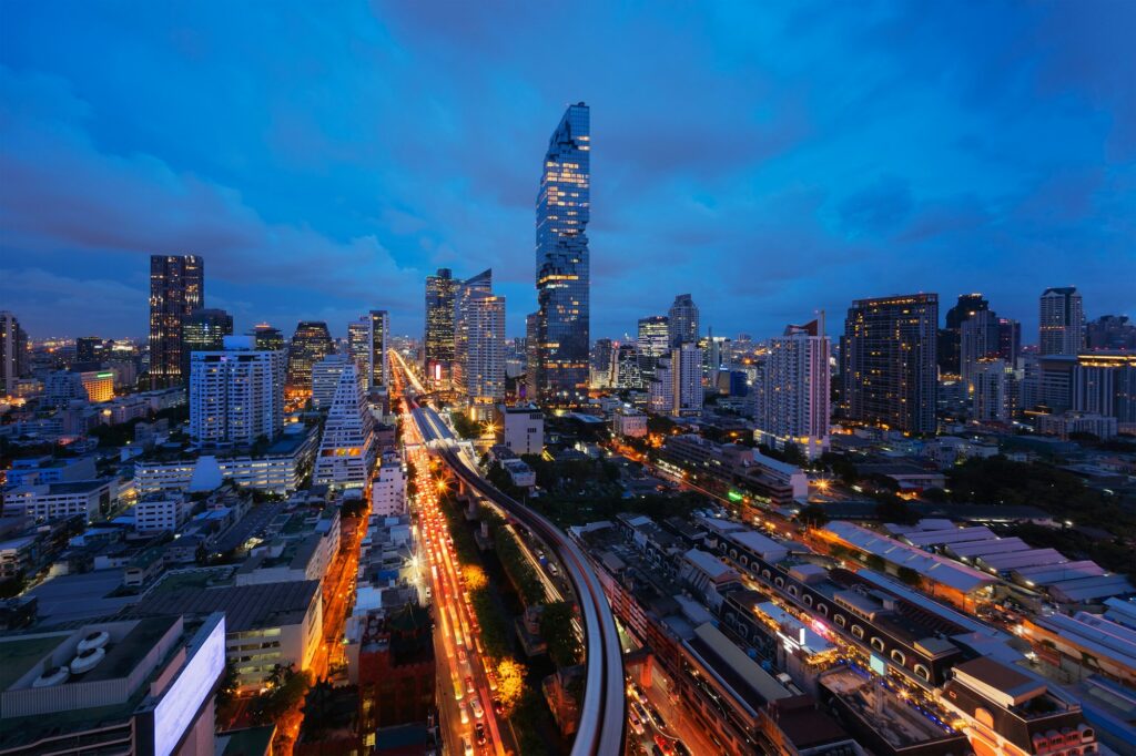 Smart city. Financial district and skyscraper buildings. Bangkok downtown area at night, Thailand.